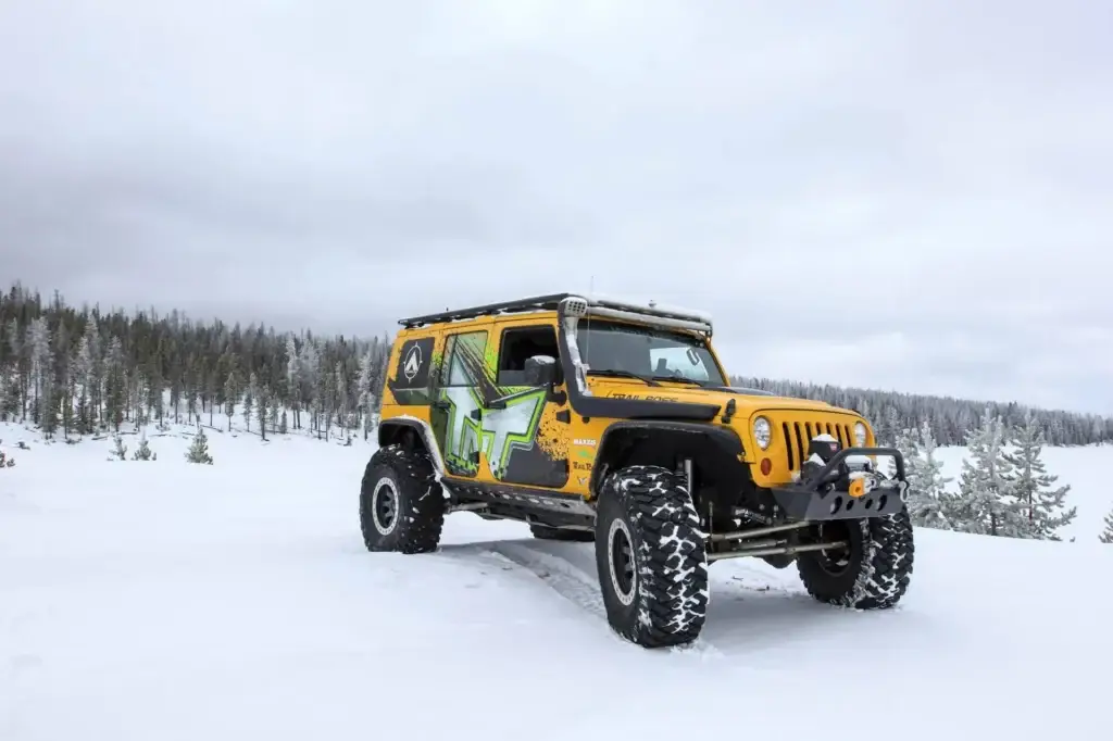 Jeep Wrangler on the snowy winter off-road trails packed with winter emergency gear.